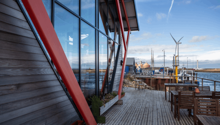 View of wind turbines and energy infrastructure from a building's terrace in Blyth.