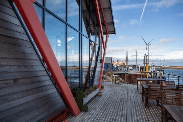 View of wind turbines and energy infrastructure from a building's terrace in Blyth.